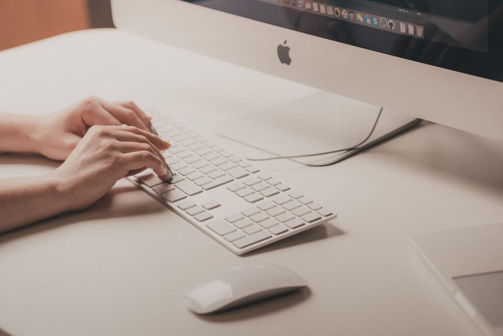 The Role of AI in the Hiring Process 1 woman's hand, typing on computer keyboard