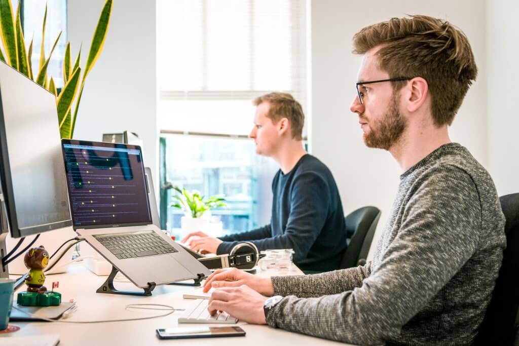 Video Interview Software: Guide for Recruiters & Hiring Managers 11 man taking a video interview on a laptop