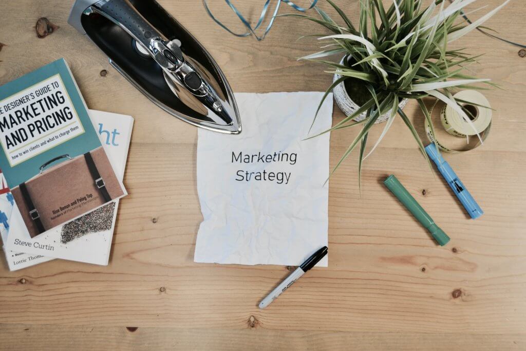 Hiring for a Marketing Agency: 9 Questions to Ask to Make the Right Hire 1 A piece of paper on a table tat says marketing strategy
