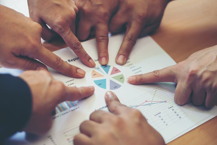The Ultimate Guide to Diversity Hiring 4 A group of Diverse Professionals Looking at Statistics