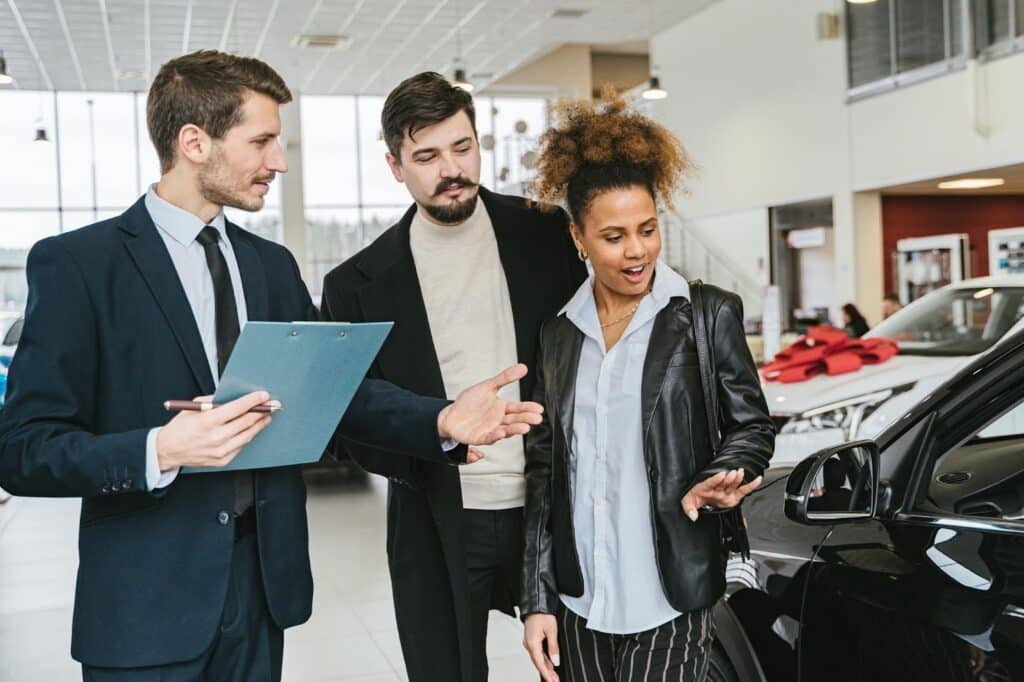 9 Vital Customer Service Hard Skills Your Representatives Need 2 A salesperson selling a car to potential buyers