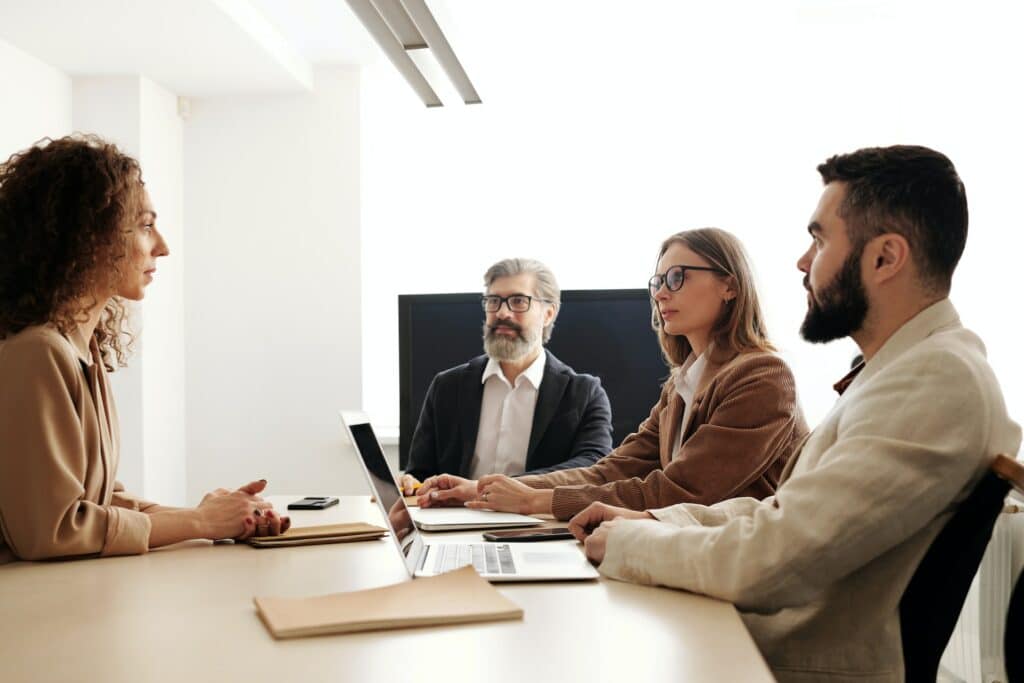 How a negative interview experience will impact your hiring process in 2023 1 A woman facing a three-person panel in a bad interview experience