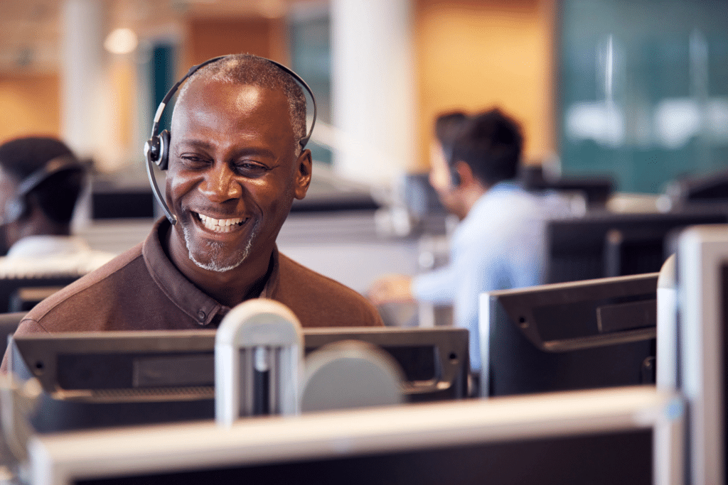 Unlocking Talent: A Comprehensive Guide to Skills-Based Assessments in BPO Recruitment 12 Man laughing with head set on