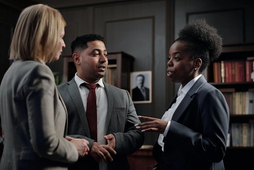 Navigating Compliance and Regulations in Pre-Employment Screening with Vervoe 1 Members of a Company’s Legal Team in a Meeting