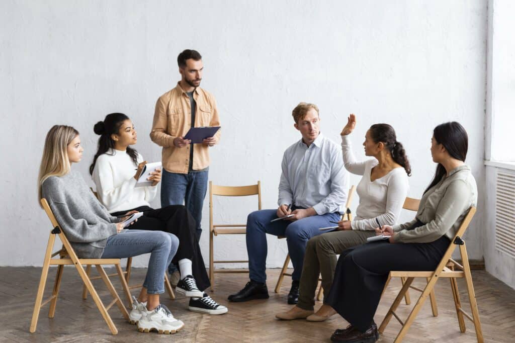 From Good to Great: Why Skill Testing More Candidates Leads to Better Hiring Decisions 6 A man addressing people in a group