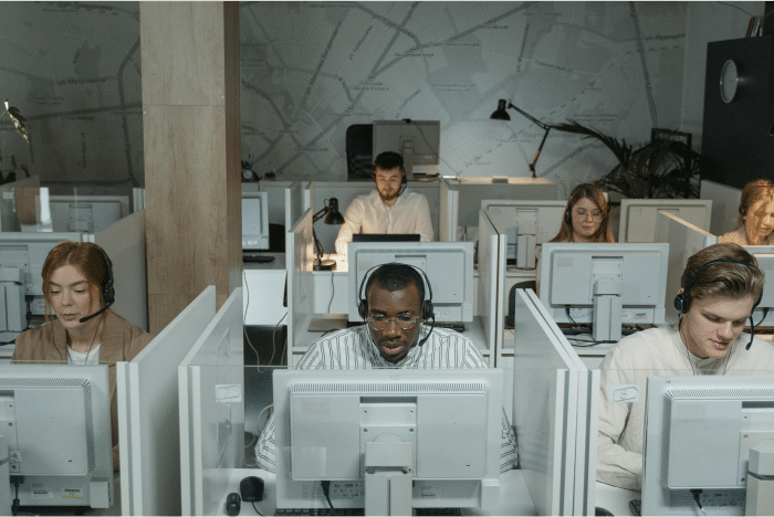 Optimizing Contact Center Recruitment: Leveraging Virtual Job Tryouts for Volume Hiring 2 Call center representatives at work
