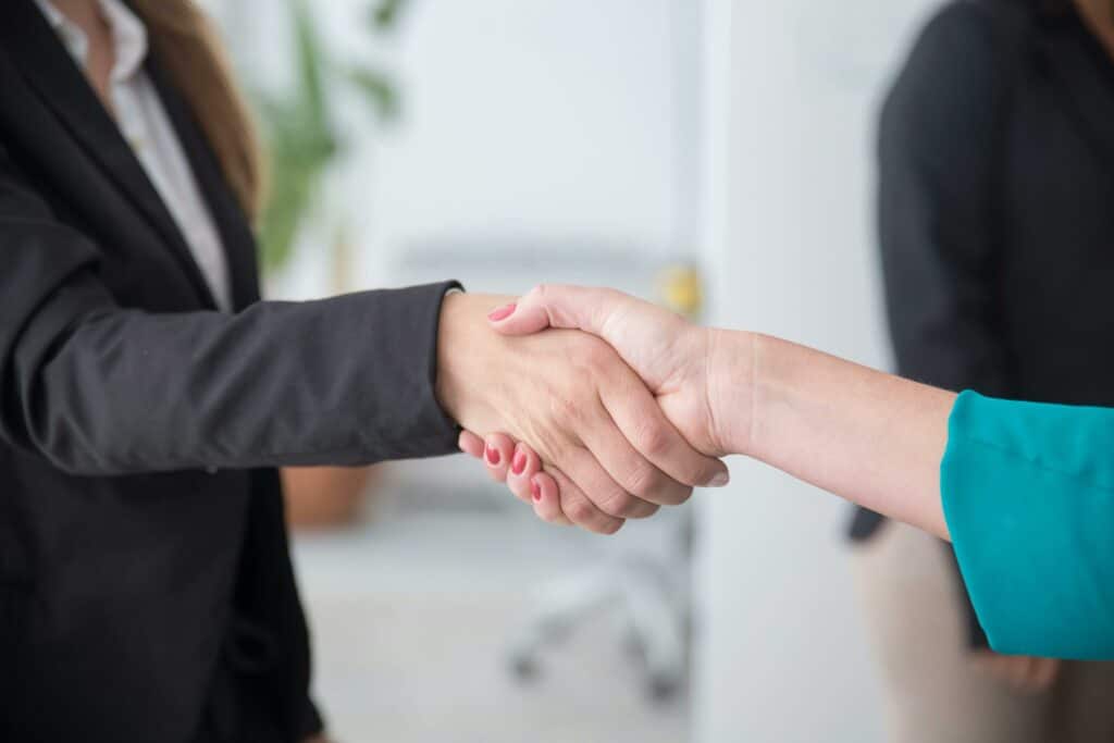 Empowering Candidates: Embracing ChatGPT in Skills Testing 4 Recruiter sharing a handshake with a candidate
