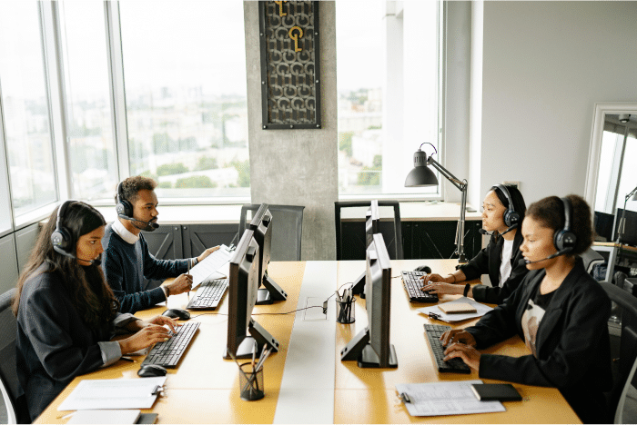 Optimizing Contact Center Recruitment: Leveraging Virtual Job Tryouts for Volume Hiring 4 Call center representatives working
