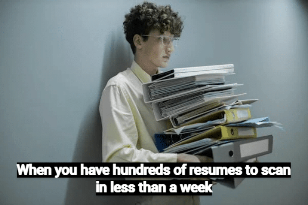 Hiring Challenges in 20 Memes 2024 Edition 11 Meme of a recruiter holding many resumes