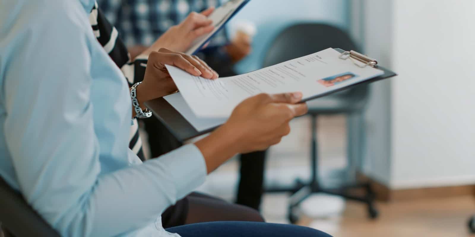 How Testing for Niche Skills Can Help You Hire for Specialized Roles 4 Female candidate holding CV