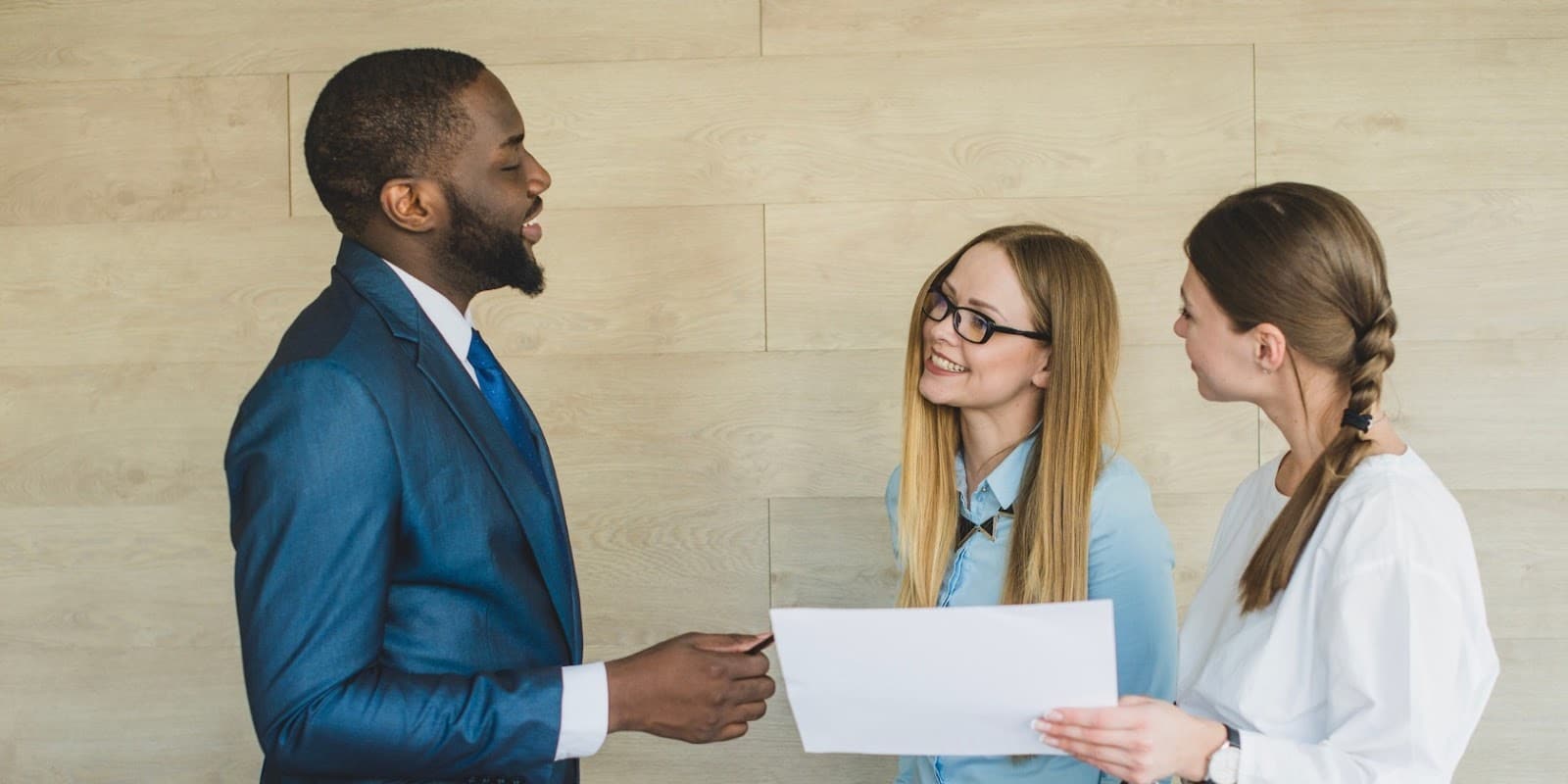 How Testing for Niche Skills Can Help You Hire for Specialized Roles 5 Three employees discussing
