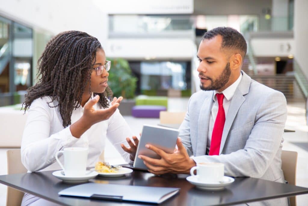 The 3 Questions Every TA Leader Should Ask Before Choosing an AI Hiring Tool 1 Two colleagues having a conversation